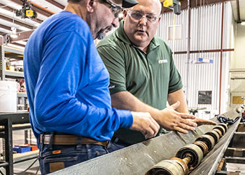 Endurance Lift employees working with ESP submersible pumps.